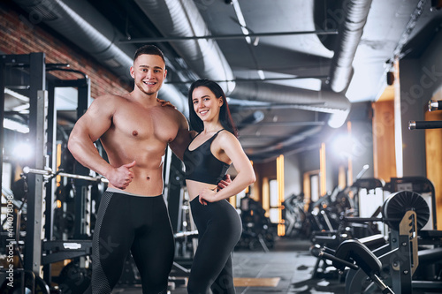 Jolly sporty couple enjoying time in gym