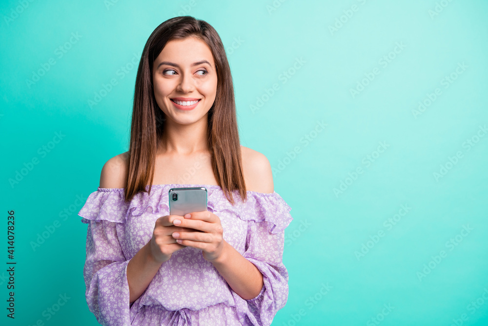 Portrait of optimistic brunette girl write telephone look empty space wear purple shirt isolated on blue color background Portrait of optimistic brunette girl write telephone look empty space wear purple shirt isolated on blue color background