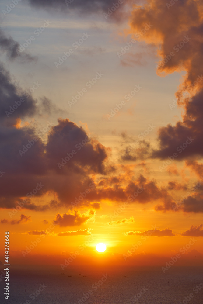 Beautiful tropical sunrise over the ocean. Nature background. Golden color.