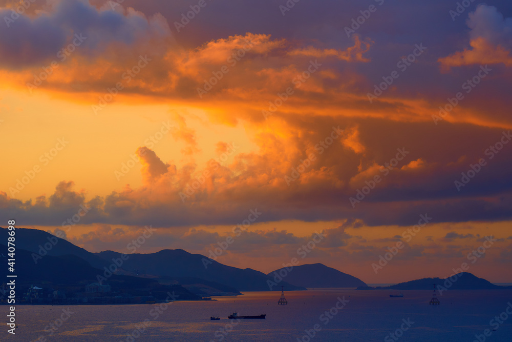 Spectacular tropical clouds over the islands. Nature background. Blue yellow colors.