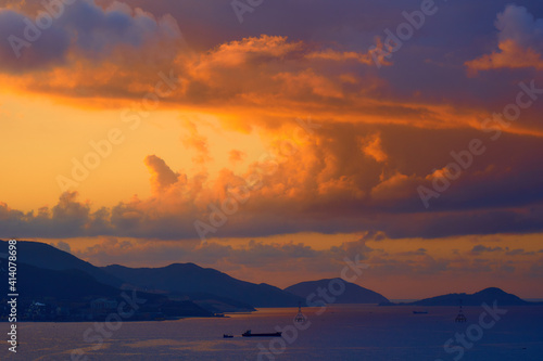 Spectacular tropical clouds over the islands. Nature background. Blue yellow colors.