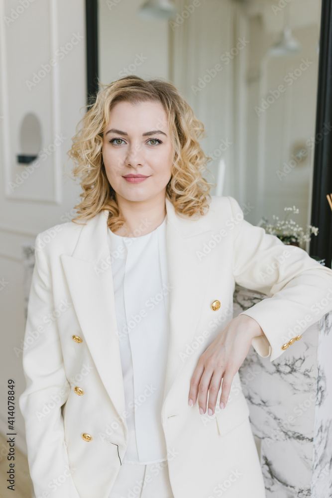 Beautiful young woman in a white suit. Business concept, business woman. Beautiful young woman in a white suit. Business concept, business woman.