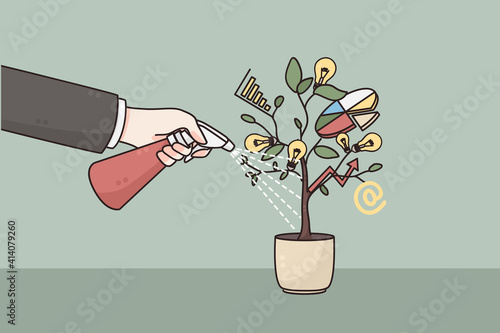 Development, business growth, strategy concept. Hand of businessman watering pot with developing project business startup with watering can meaning care investments and support