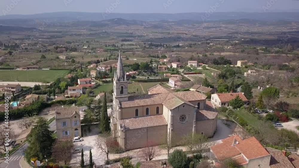 View on a typical French town Bonnieux in Provence, France with old church, streets and houses, pedestal aerial shot View on a typical French town Bonnieux in Provence, France with old church, streets and houses, pedestal aerial shot