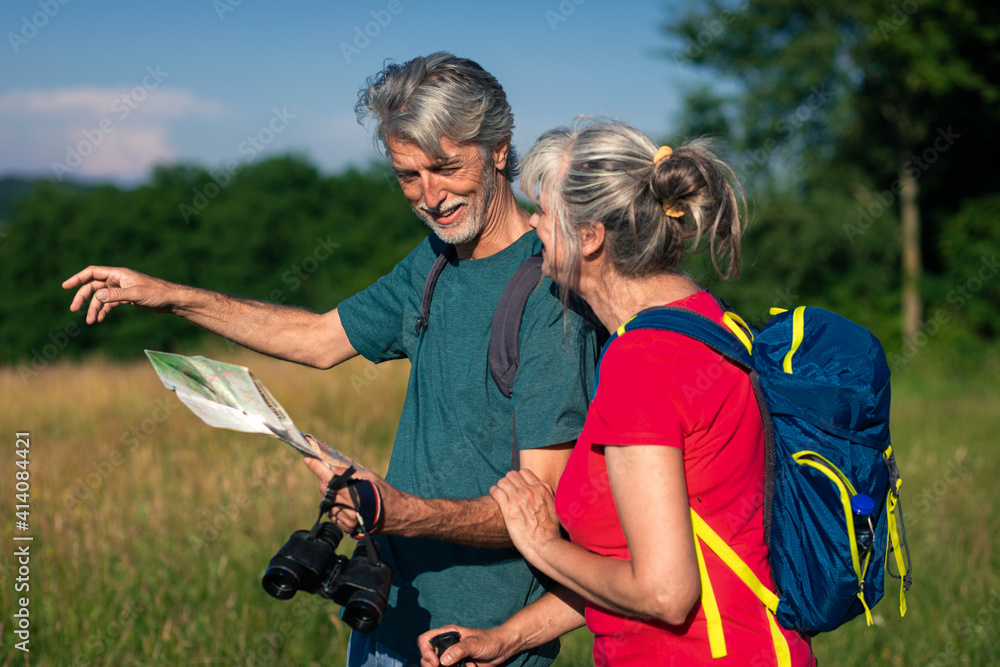 Active senior couple with backpacks hiking in nature. Active senior couple with backpacks hiking in nature.