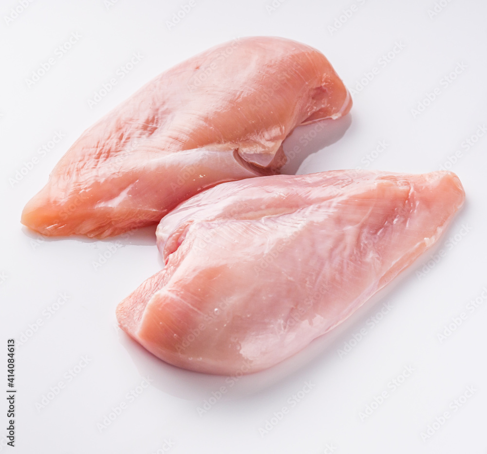 raw chicken fillet on a white acrylic background raw chicken fillet on a white acrylic background