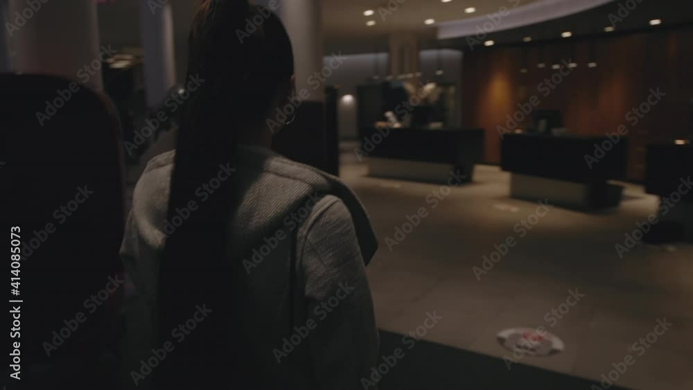 American teenager girl woman entering lobby reception of hotel motel building walking towards disk with personell helping book a room to sleep on vacation resort travelling travler roadtrip fancy home American teenager girl woman entering lobby reception of hotel motel building walking towards disk with personell helping book a room to sleep on vacation resort travelling travler roadtrip fancy home