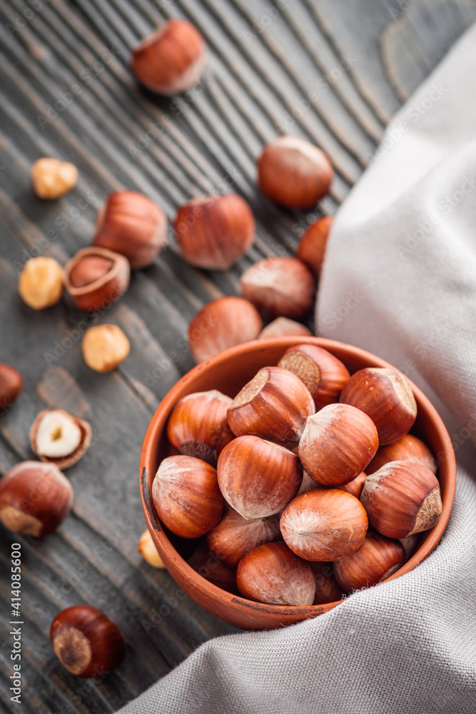 fresh natural hazelnuts on a dark wooden rustic background fresh natural hazelnuts on a dark wooden rustic background