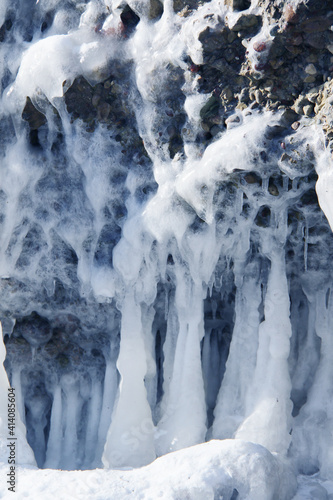 rocks on the beach covered in ice