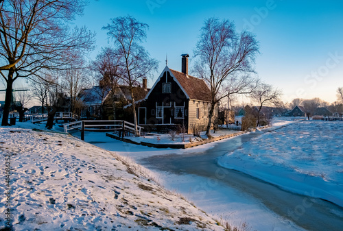 snow covered windmill village in the Zaanse Schans Netherlands, historical wooden windmills in winter Zaanse Schans Holland during winter photo