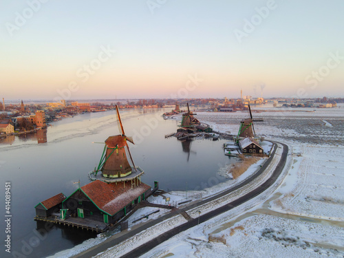 snow covered windmill village in the Zaanse Schans Netherlands, historical wooden windmills in winter Zaanse Schans Holland during winter photo