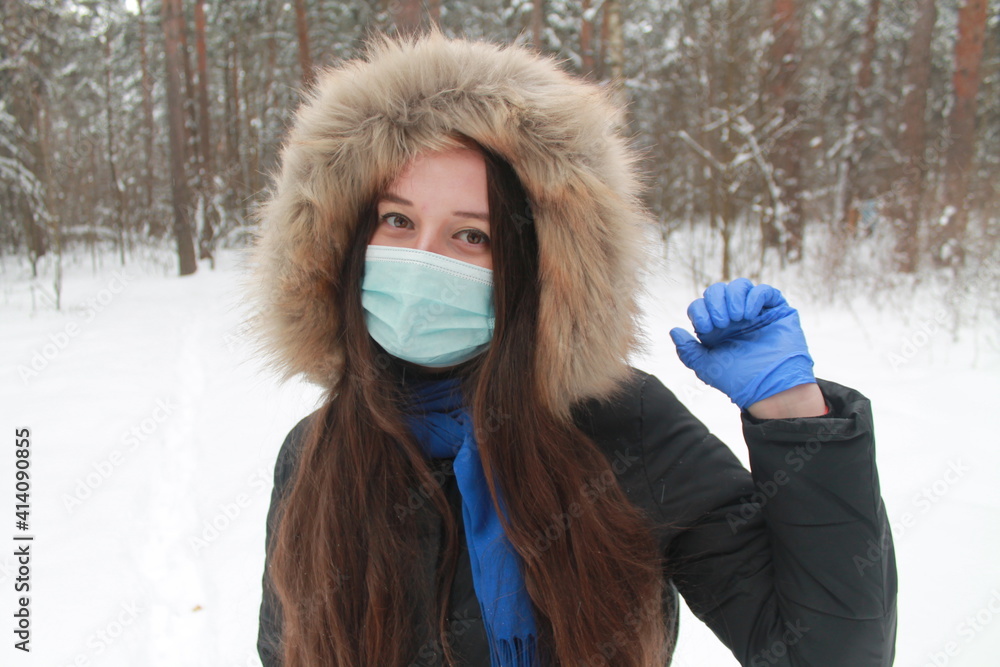 A girl in a mask and gloves in the forest A girl in a mask and gloves in the forest