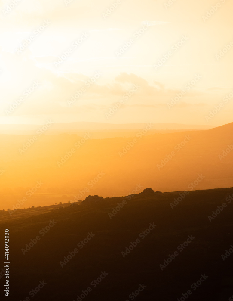 Sunrise sunset layered golden orange landscape.