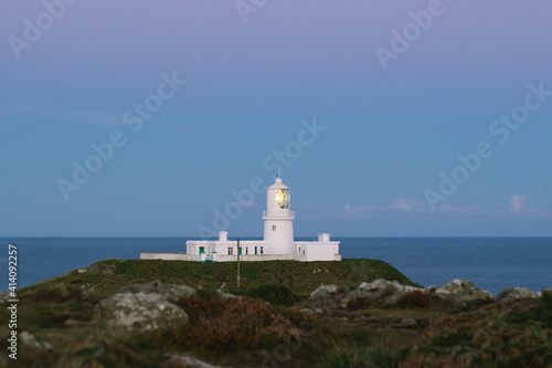 Lighthouse on the coast at sunrise.