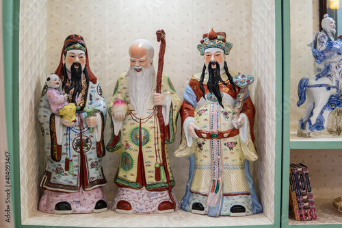 Closeup of the traditional ceramic statues of the Chinese gods of luck photo