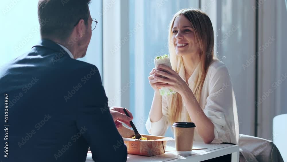 Businessman and woman talking and laughing in restaurant Businessman and woman talking and laughing in restaurant