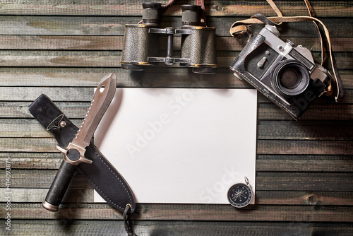 a set of equipment for a hike on a dark wooden background. close-up, copy space.