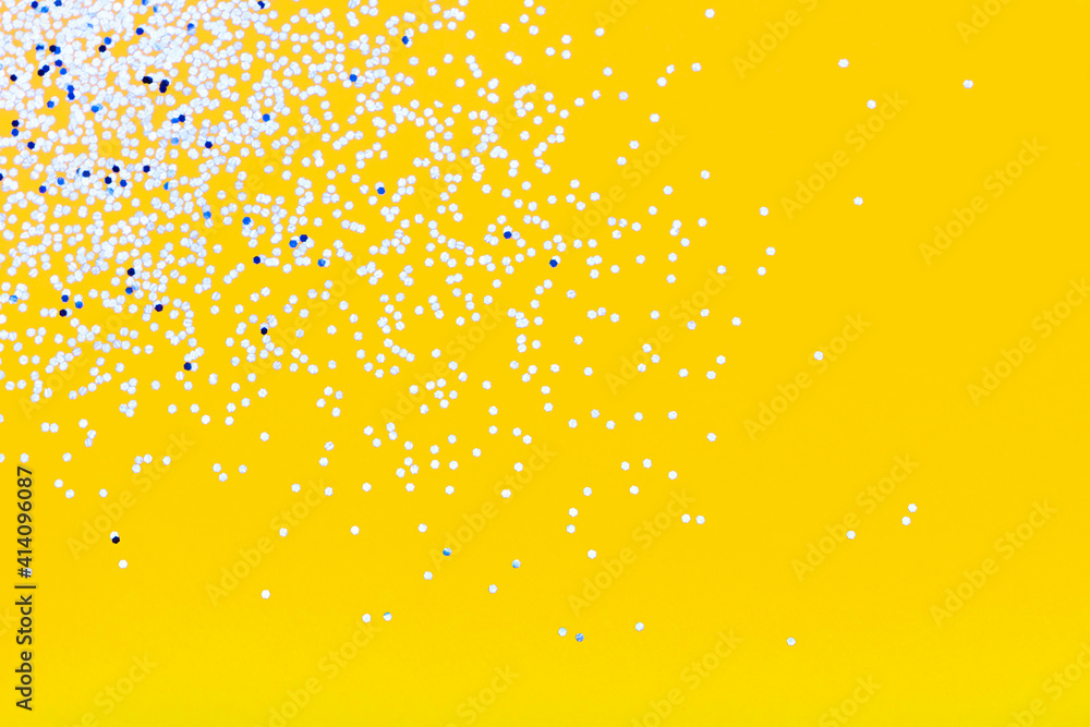Yellow festive background with blue sparkles. The concept of the celebration, the day of St. Valentine, New Year, birthdays, ceremonies, events, etc. Yellow festive background with blue sparkles. The concept of the celebration, the day of St. Valentine, New Year, birthdays, ceremonies, events, etc.