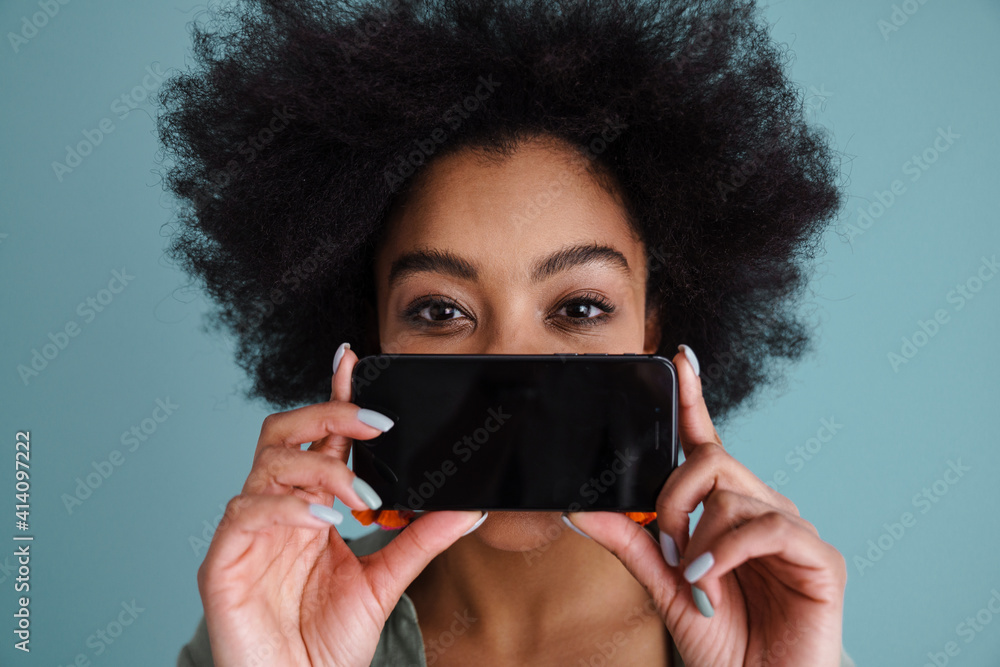 Joyful african american girl taking photo on mobile phone Joyful african american girl taking photo on mobile phone
