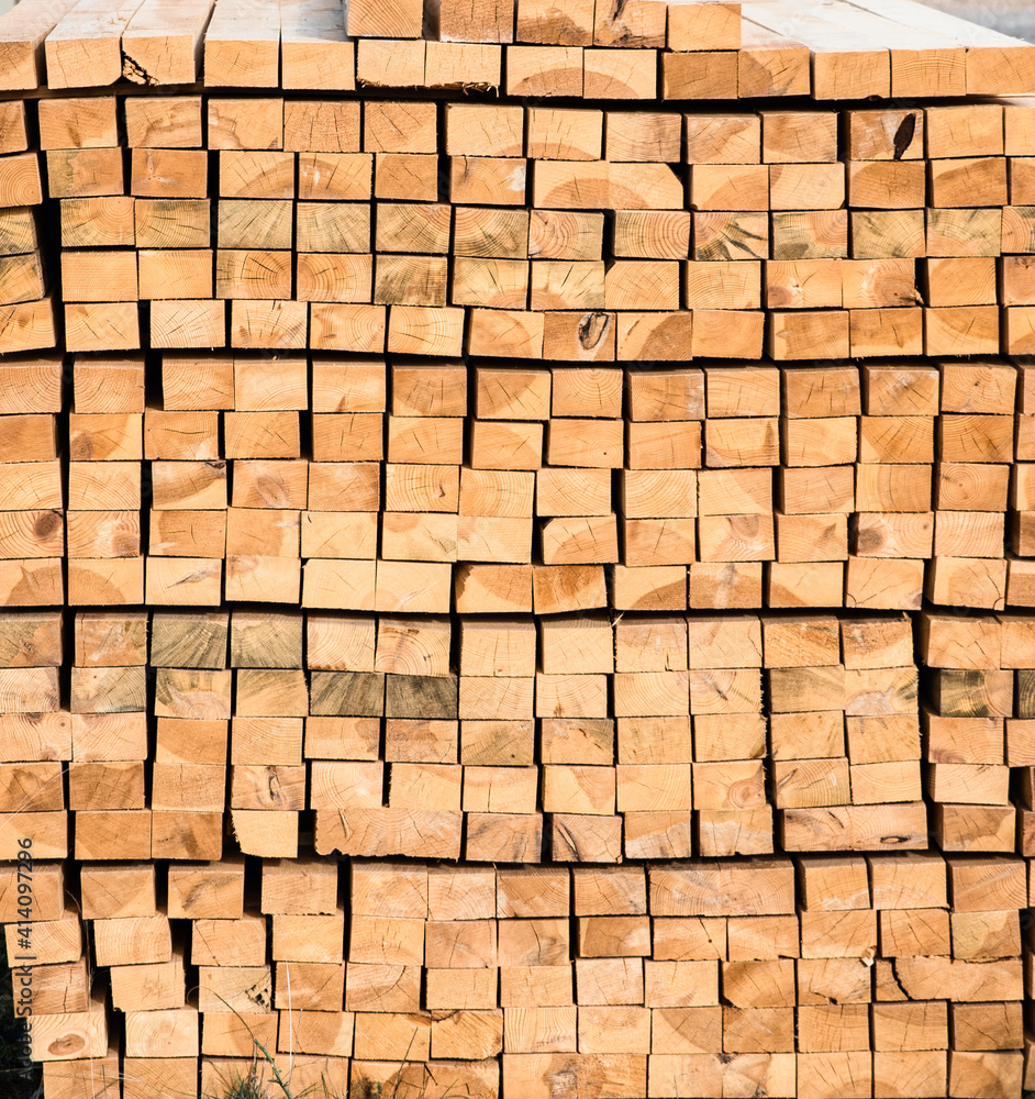 Square wooden planks stacked on a construction site. Square wooden planks stacked on a construction site.