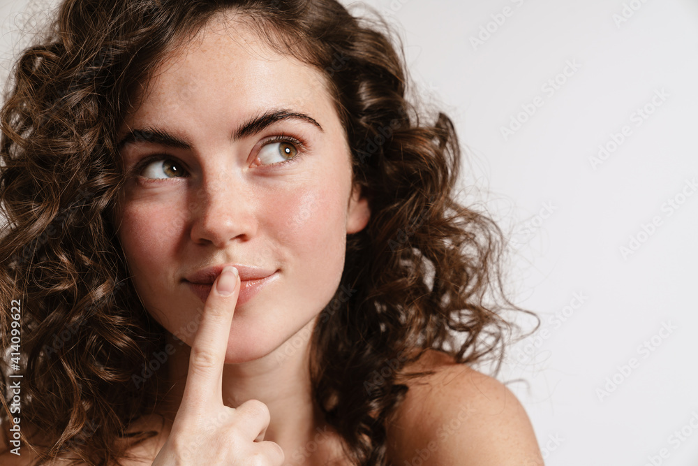 Pleased sensual shirtless girl showing silence gesture Pleased sensual shirtless girl showing silence gesture