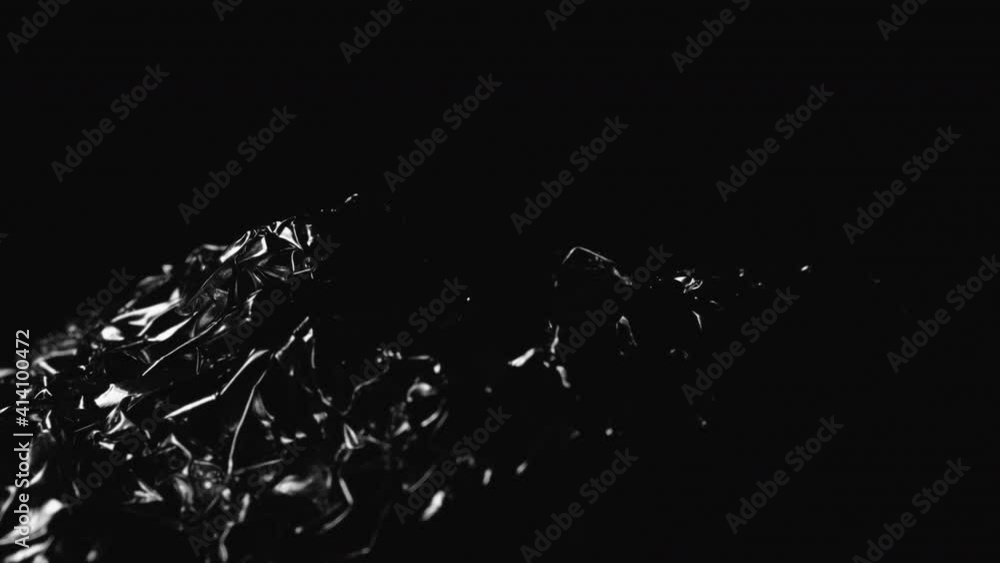 Light Reflecting On Crumpled Aluminum Foil. - close up Light Reflecting On Crumpled Aluminum Foil. - close up