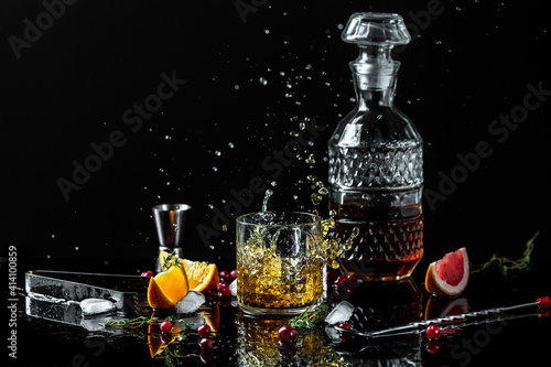 alcoholism, alcohol addiction and people concept - male alcoholic with bottle and glass drinking whiskey at night.Businessman drinks whiskey