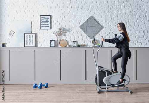 Wallpaper Mural Training sportive woman at home, doing sport interior concept, decorative background and ride a bike style. Torontodigital.ca