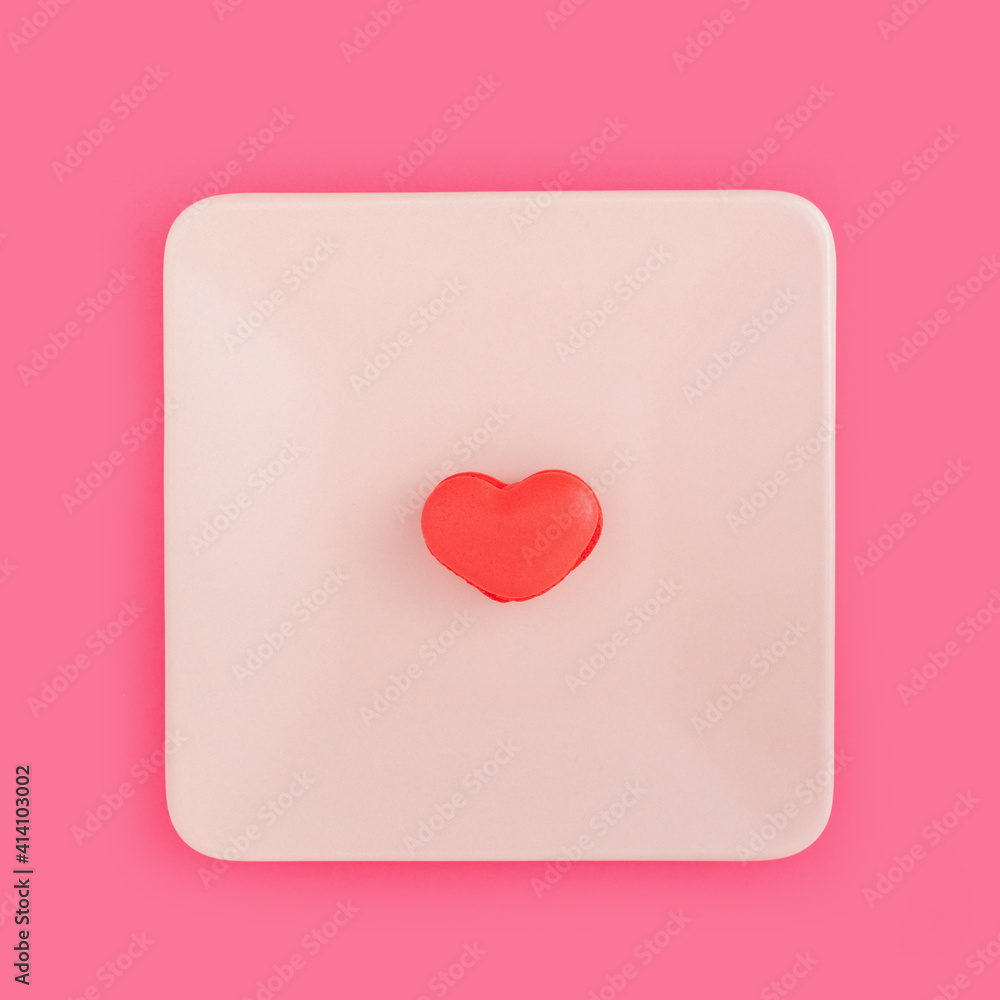 Creative minimal love concept with heart shaped macaroon biscuit served on plate. Flat lay design Creative minimal love concept with heart shaped macaroon biscuit served on plate. Flat lay design