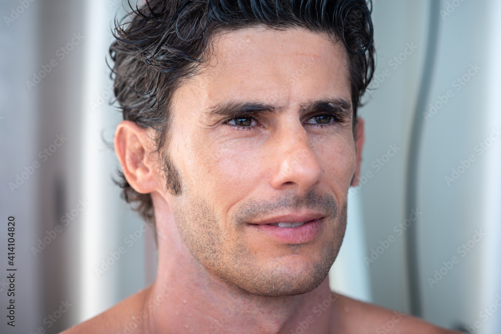 Portrait of handsome man, shirtless surfer with white teeth smile and white surf boards on background in Maldives Portrait of handsome man, shirtless surfer with white teeth smile and white surf boards on background in Maldives