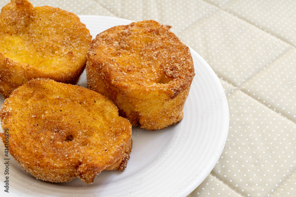 baked or fried bread with sugar and cinnamon. Dessert called Rabanada, Torrija or golden bread. cuisine from Brazil, Portugal and Spain. Space to text.