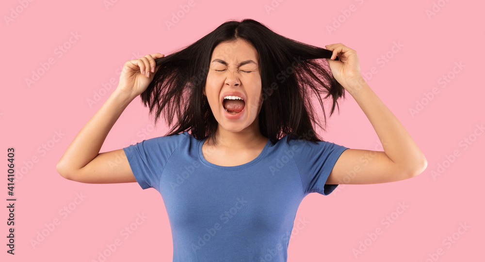 Portrait of angry emotional asian woman screaming Portrait of angry emotional asian woman screaming