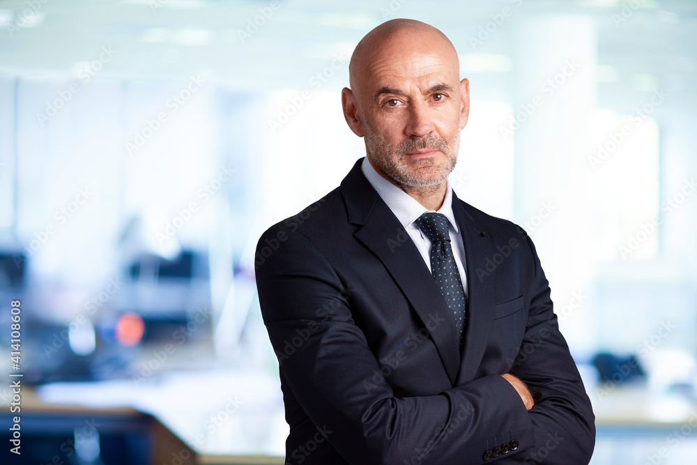 Confident businessman portrait while standing in the office Confident businessman portrait while standing in the office