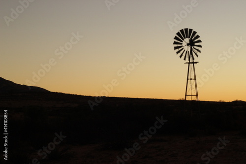 Windmill at sunset on the farm