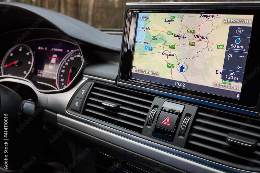 Foto Stock GRODNO, BELARUS - DECEMBER 2019: Audi A6 4G C7 interior in dark  tones with display with GPS navigation map multimedia system climate  control panels example of modern car technological equipment.