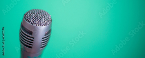 Clubhouse podcast green banner with studio microphone and light wave. Professional broadcast microphone recording sound with waveform signal on green background