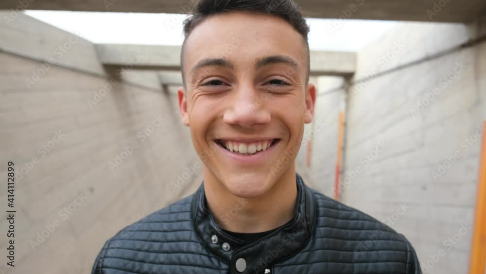 Close up of one young man smiling and laughing looking at the camera having fun. Portrait of teenager opening eyes feeling good.
Close up of one young man smiling and laughing looking at the camera having fun. Portrait of teenager opening eyes feeling good.
