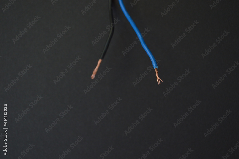 two wires with electricity on a black background two wires with electricity on a black background