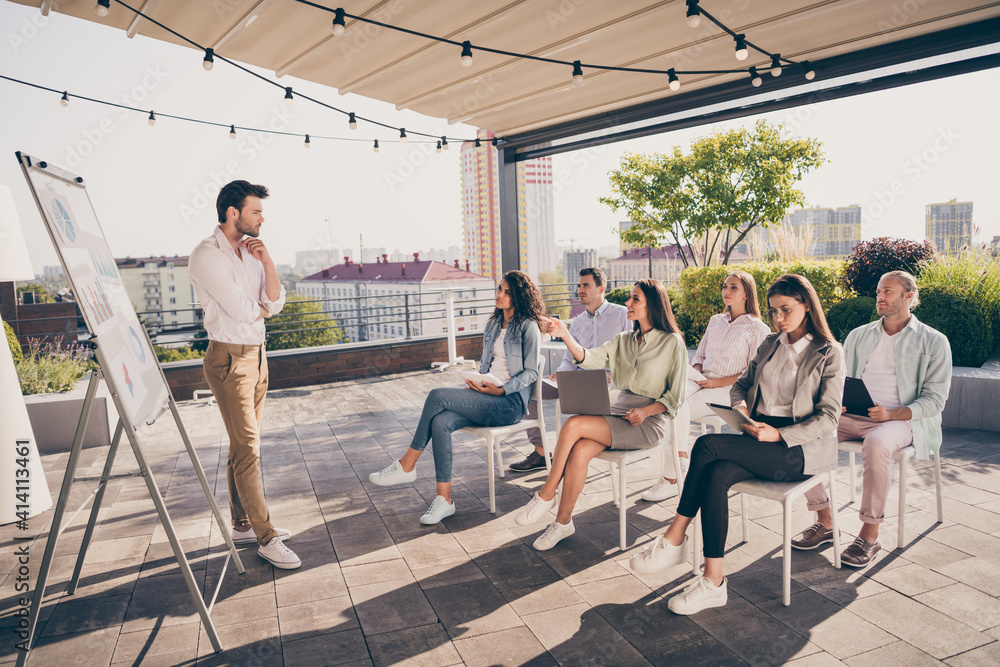 Full size photo of young man leader boss thinking about question having meeting with colleagues outside outdoors Full size photo of young man leader boss thinking about question having meeting with colleagues outside outdoors