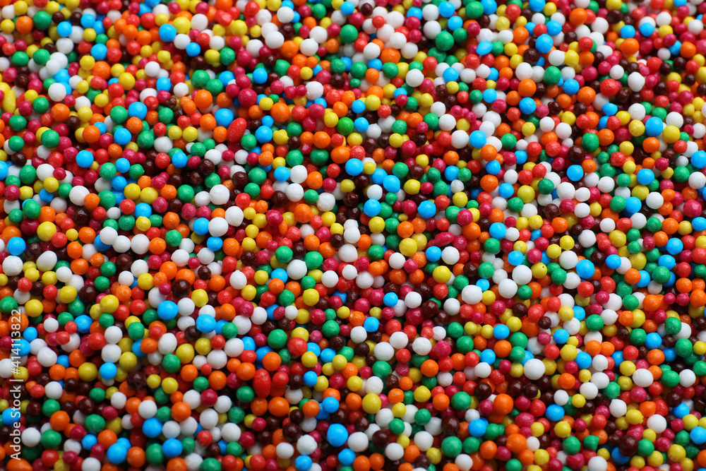 Bright colorful sprinkles as background, top view. Confectionery decor Bright colorful sprinkles as background, top view. Confectionery decor