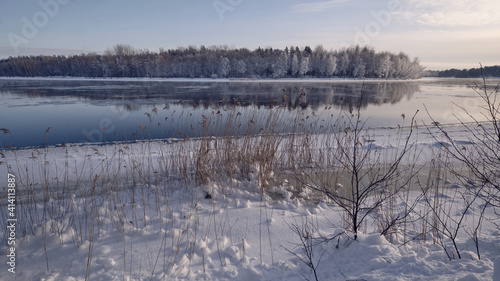 Winter landscape: the Burnaya river flows into Lake Ladoga, trees covered with hoarfrost, panoramic view © gogiya