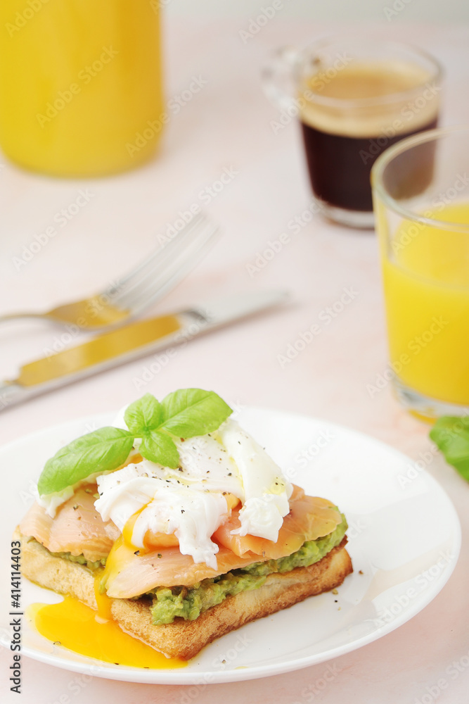 Breakfast with a sandwich with poached egg and avocado Breakfast with a sandwich with poached egg and avocado