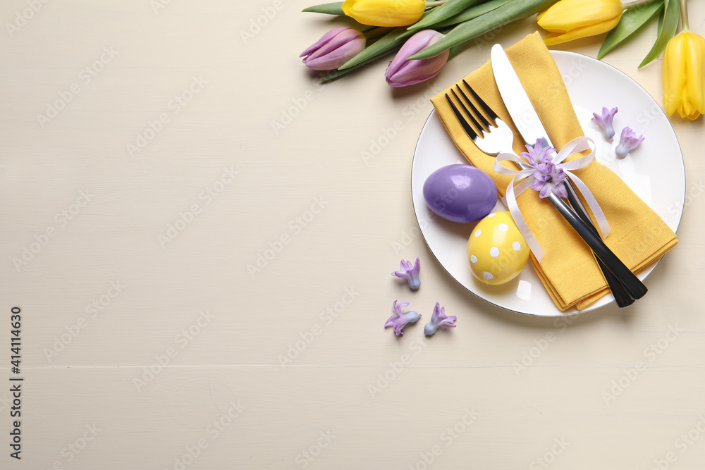 Festive Easter table setting with eggs on beige background, flat lay. Space for text