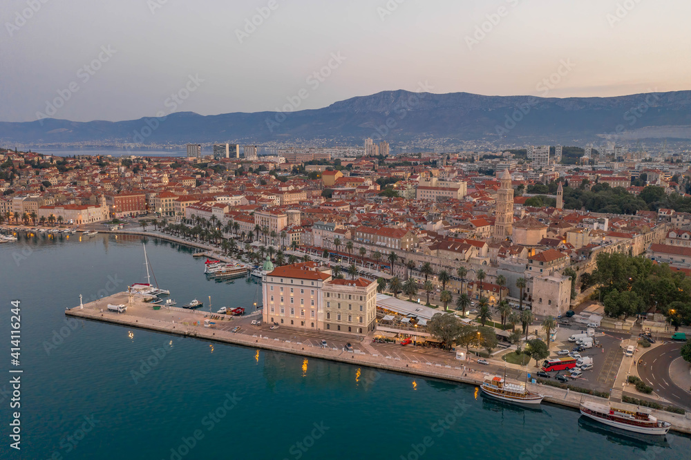 Aerial drone shot of Diocletian Palace by port riva in Split old town before sunrise in early morning in Croatia