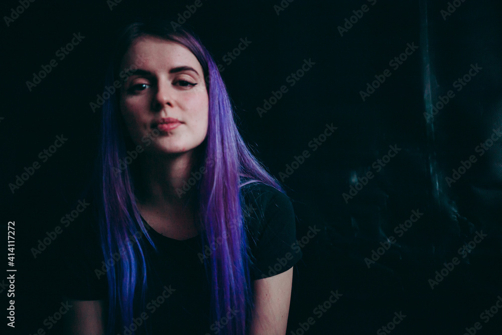 a girl with purple hair thinks on a black background a girl with purple hair thinks on a black background