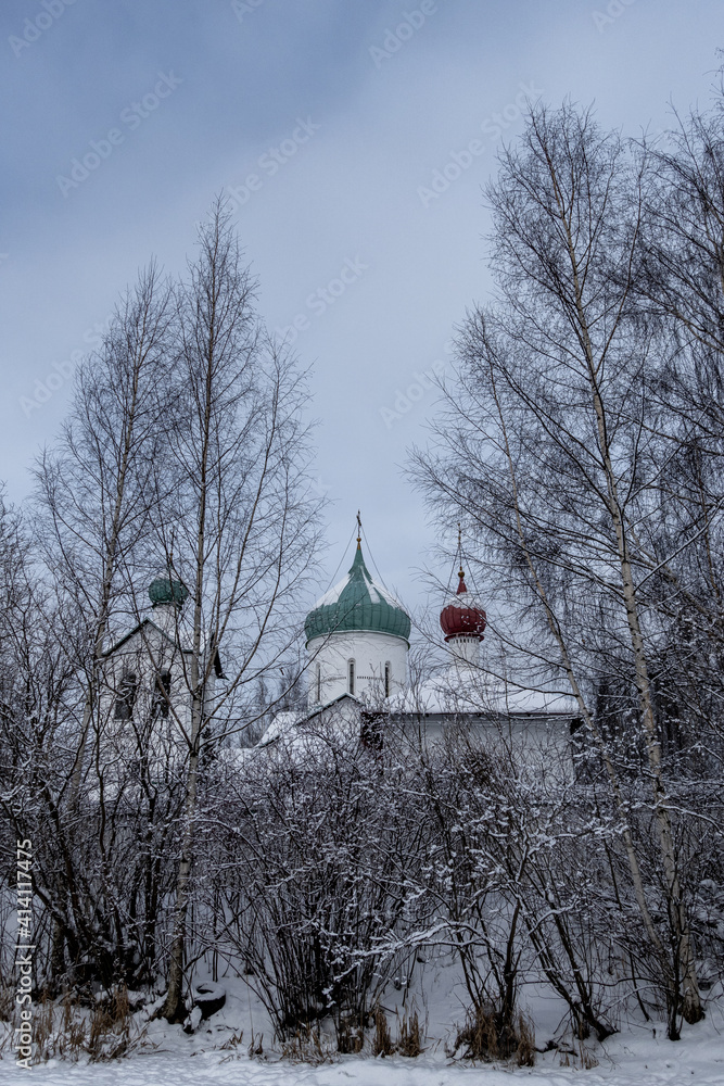 Church in the snow covered with trees 