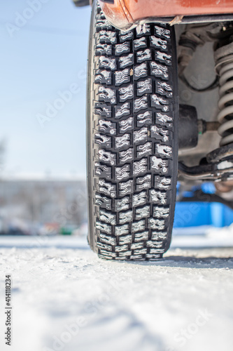 Car tires on the winter road are covered with snow. © Анатолий Савицкий