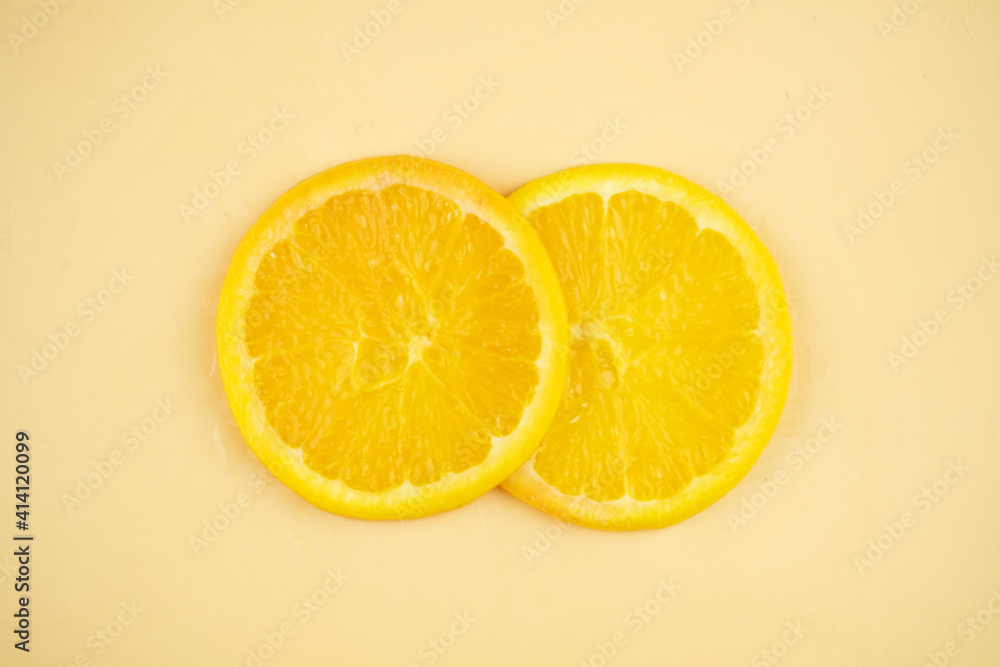 Sliced orange on yellow background Sliced orange on yellow background