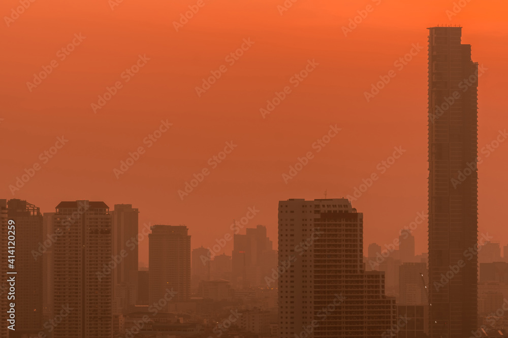 Air pollution. Smog and fine dust of pm2.5 covered city in the morning with red sunrise sky. Cityscape with polluted air. Dirty environment. Urban toxic dust. Unhealthy air. Urban unhealthy living.