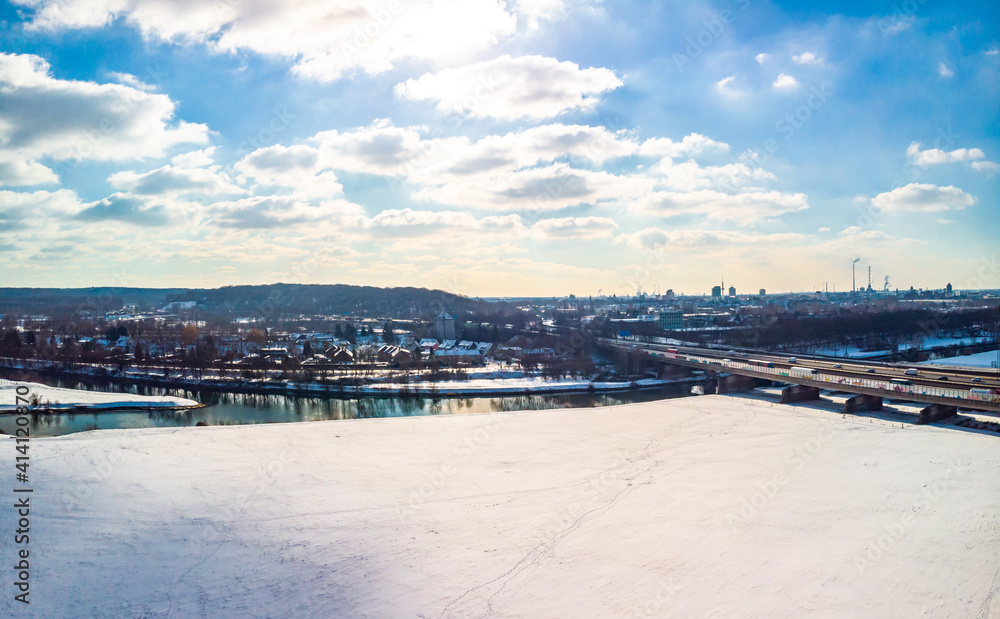 View of the snow-covered skyline of Duisburg on a sunny winter day from above